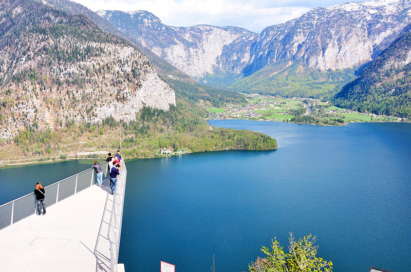 Tourists walking to the spectacular viewing platform World Heritage View on the Salzberg, 350 meters above the rooftops of Hallstatt